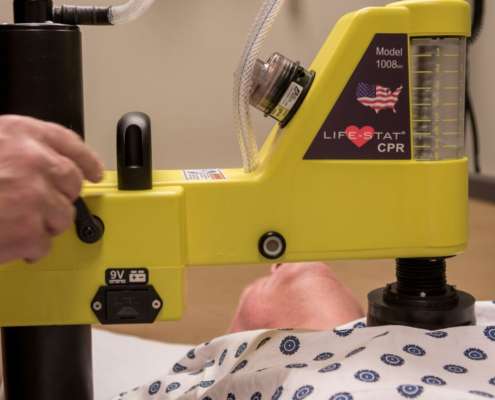 life-stat mechanical CPR machine on adult