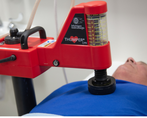 Thumper on Patient 1500x500 Michigan Instruments thumper CPR machine on adult in hospital